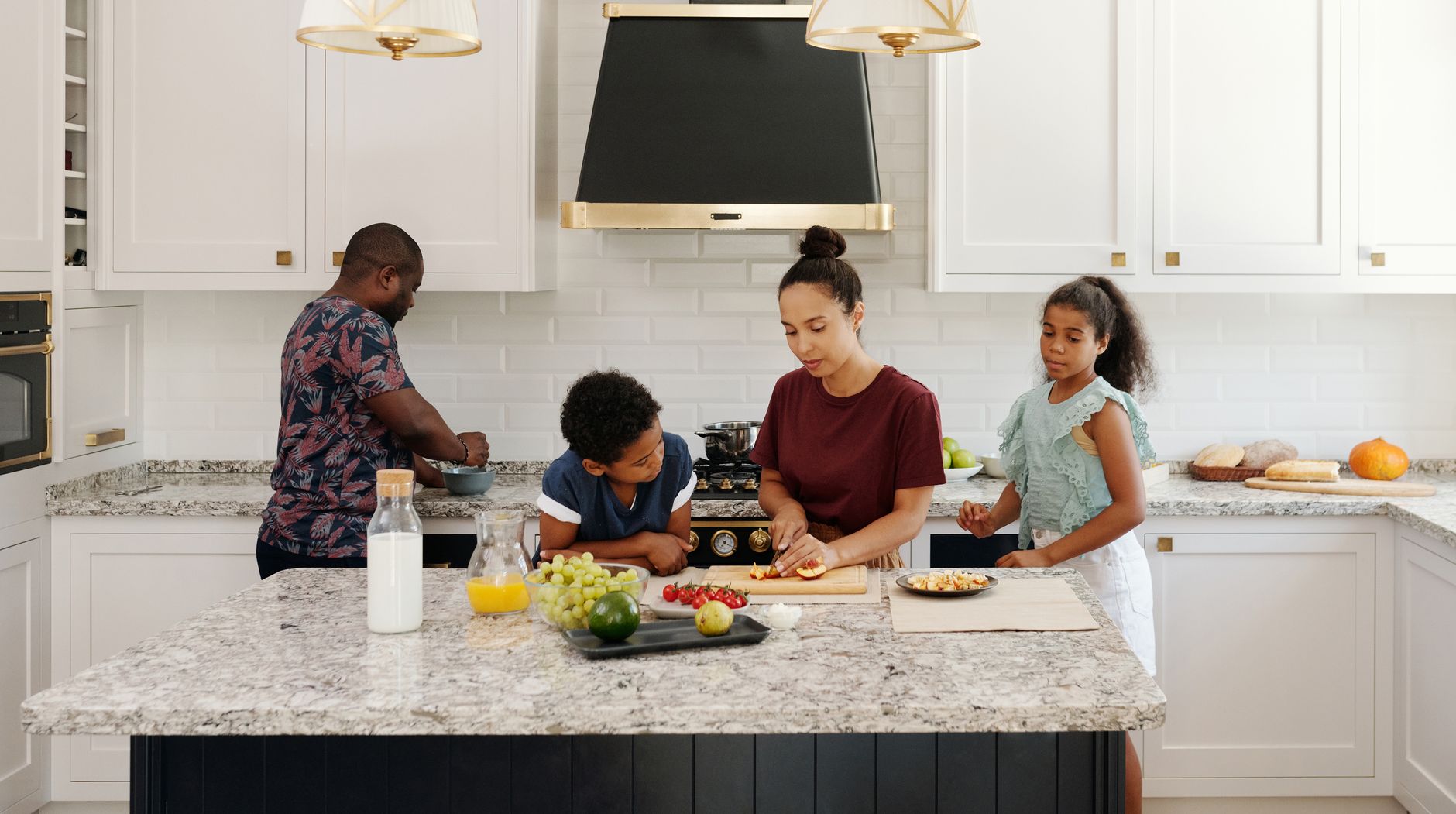 Bright kitchen with a stone countertop and fresh fruit on a cutting board
