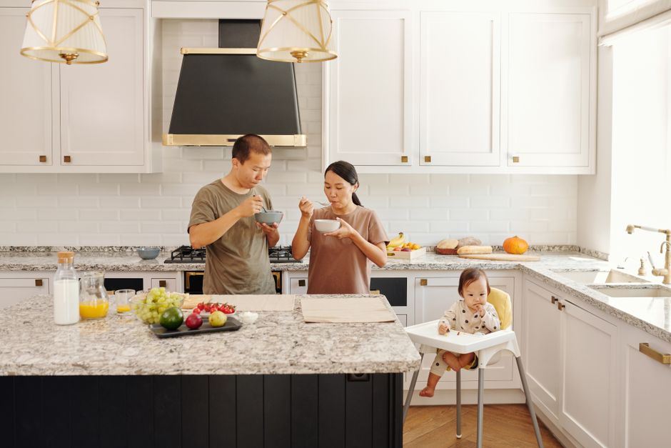Bright kitchen with granite countertops and wooden cabinets.