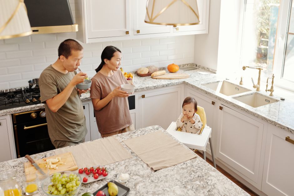 Kitchen with a long granite countertop and stainless steel sink.